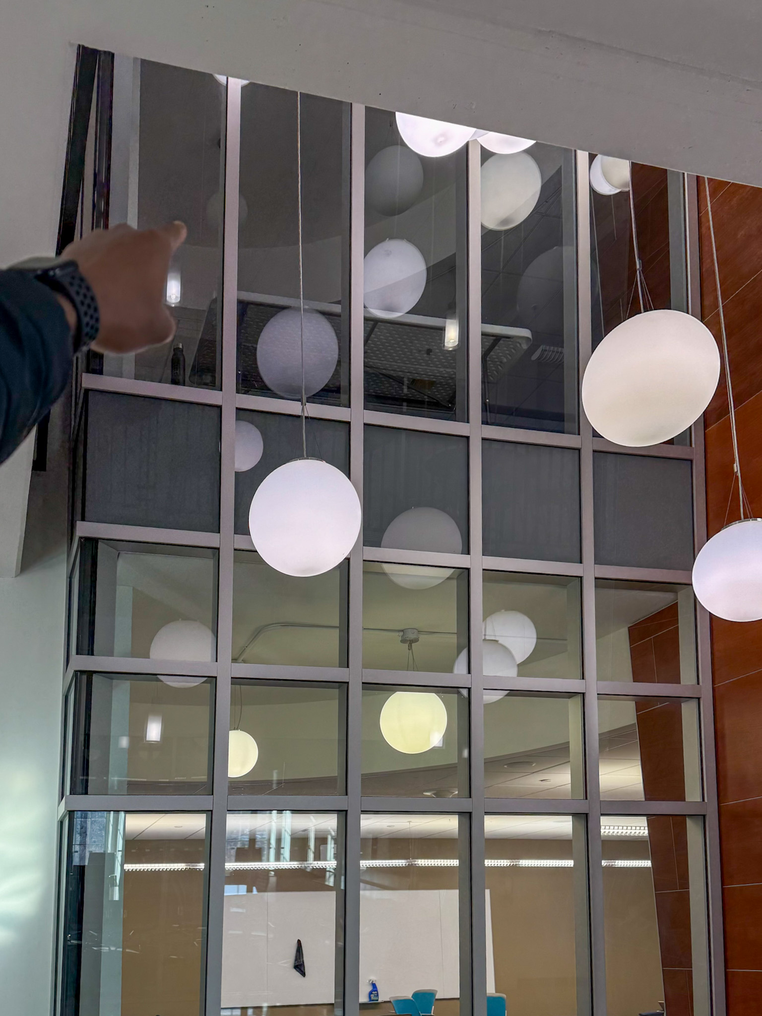 View of globe lights in Malone atrium with room above